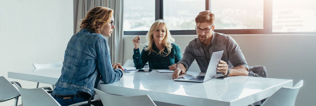 Team working through a technology plan at a conference table